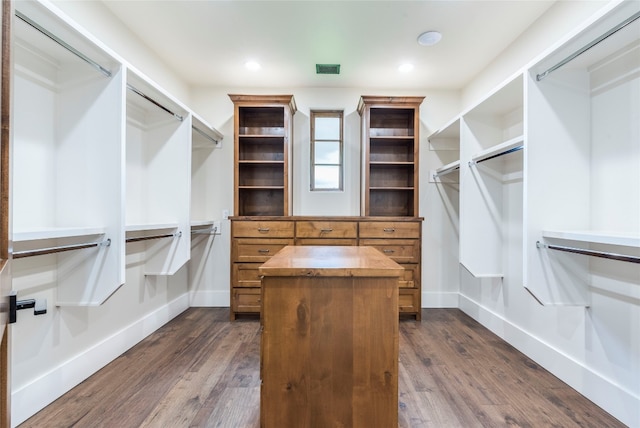 spacious closet with dark hardwood / wood-style floors