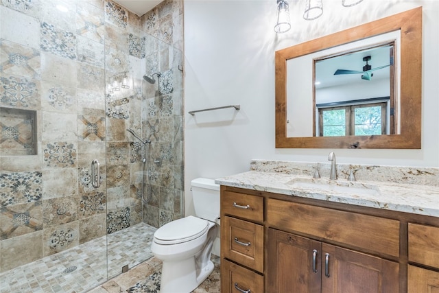 bathroom with a shower with door, vanity, and toilet