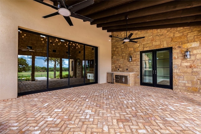 view of patio / terrace with exterior kitchen, ceiling fan, and french doors