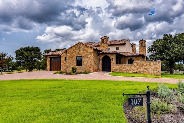 mediterranean / spanish home with a garage and a front yard