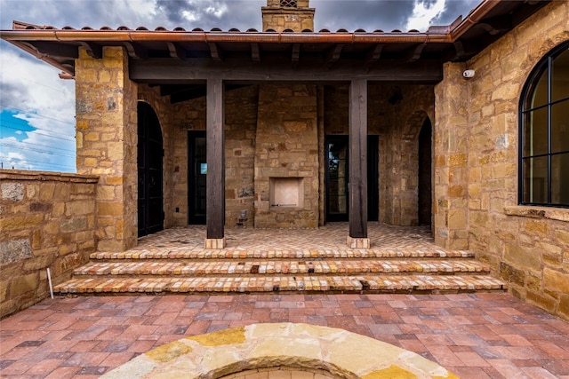 view of exterior entry featuring a patio