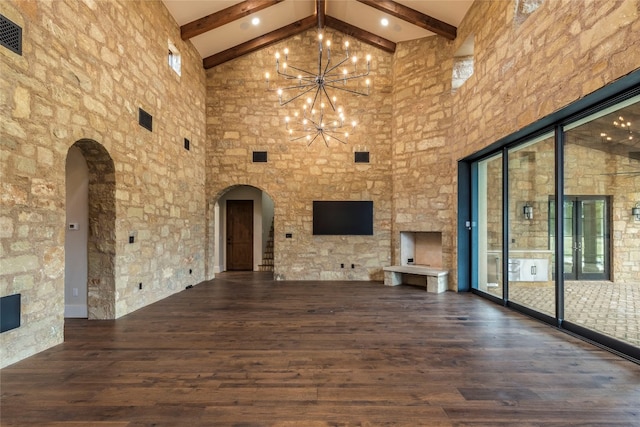 unfurnished living room featuring beamed ceiling, high vaulted ceiling, a notable chandelier, and dark hardwood / wood-style floors