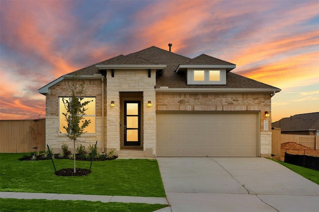 view of front of house with a garage and a yard