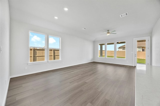 unfurnished living room featuring ceiling fan and light wood-type flooring