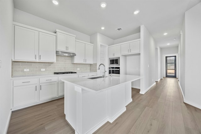 kitchen with white cabinets, light wood-type flooring, sink, and stainless steel appliances