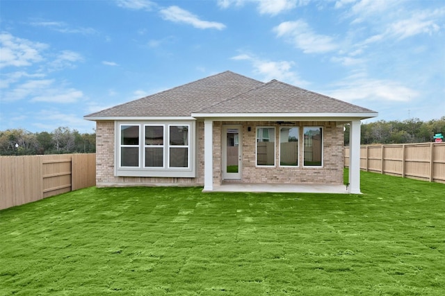 back of property featuring a yard and a patio area