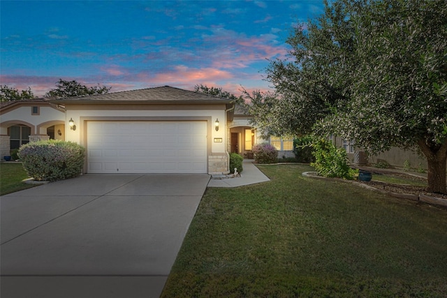 view of front of property with a lawn and a garage