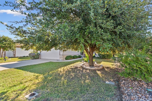 obstructed view of property featuring a front yard and a garage