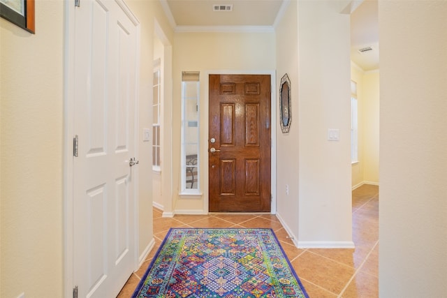 hallway featuring crown molding and light tile patterned floors