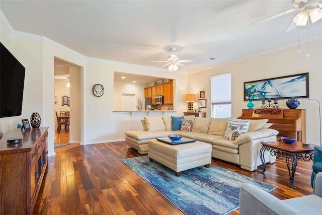 living room featuring ornamental molding, ceiling fan, and hardwood / wood-style floors