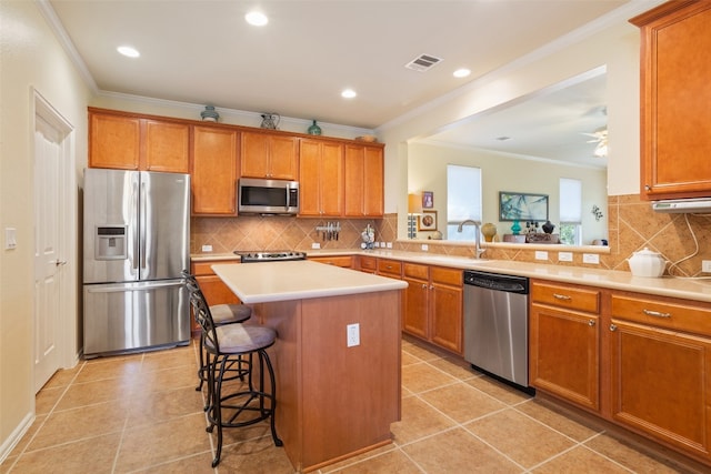 kitchen featuring a center island, stainless steel appliances, light tile patterned flooring, kitchen peninsula, and a breakfast bar area