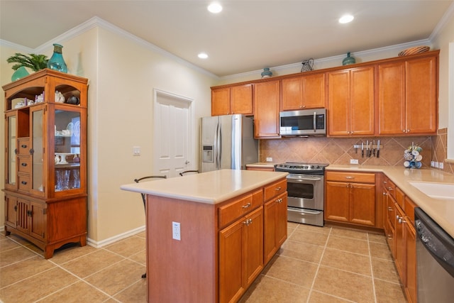 kitchen with tasteful backsplash, light tile patterned floors, appliances with stainless steel finishes, and a center island