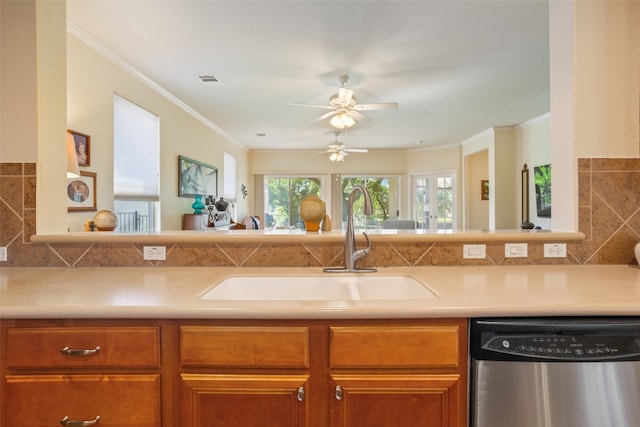 kitchen featuring decorative backsplash, ceiling fan, sink, dishwasher, and ornamental molding