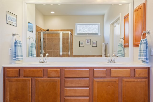 bathroom featuring vanity and a shower with shower door