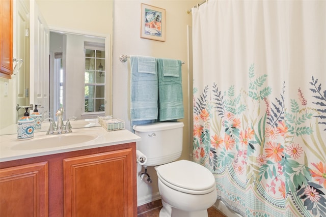 bathroom with vanity, walk in shower, and toilet