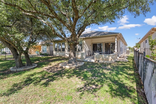 back of property featuring a patio area and a lawn