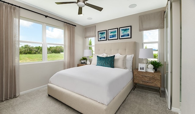 bedroom featuring light carpet and ceiling fan