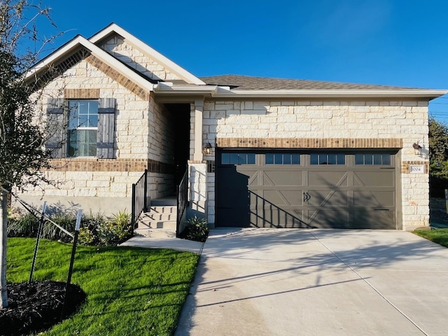 view of front of property featuring a garage and a front yard