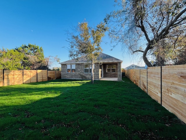 back of property featuring a yard and a patio area