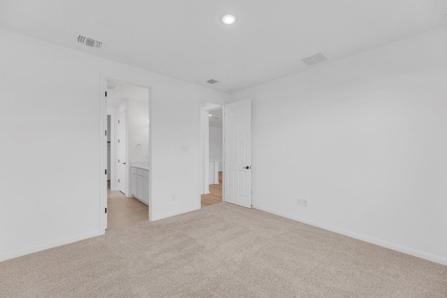 1004 Stonehill Dr, Georgetown, TX 78633 - unfurnished bedroom featuring light carpet, baseboards, recessed lighting, and ensuite bathroom