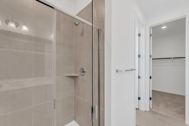 1004 Stonehill Dr, Georgetown, TX 78633 - full bathroom with a stall shower, a walk in closet, tile patterned flooring, and recessed lighting