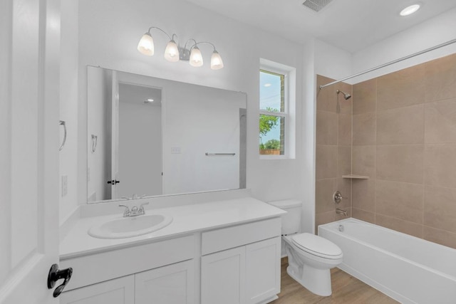 1004 Stonehill Dr, Georgetown, TX 78633 - full bathroom with toilet, tub / shower combination, vanity, and wood finished floors