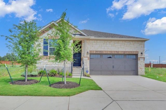 1004 Stonehill Dr, Georgetown, TX 78633 - view of front of property with stone siding, a front lawn, an attached garage, concrete driveway, and roof with shingles