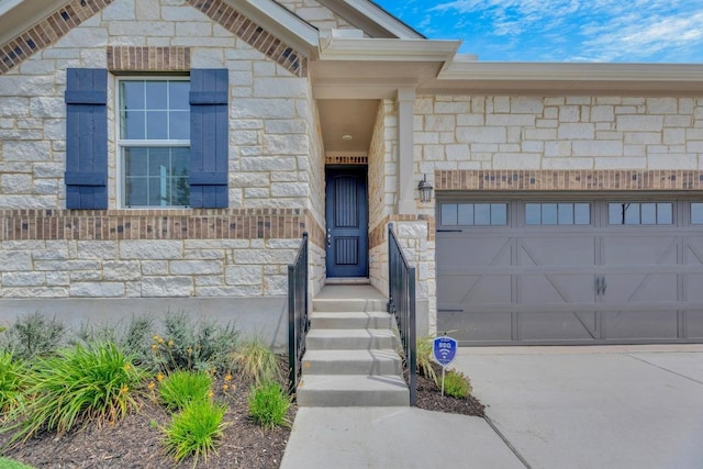 1004 Stonehill Dr, Georgetown, TX 78633 - entrance to property with an attached garage, stone siding, and concrete driveway