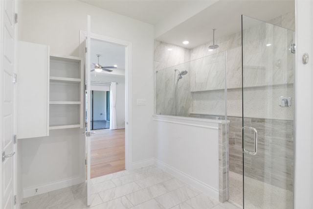 bathroom featuring ceiling fan, a shower with shower door, and wood-type flooring