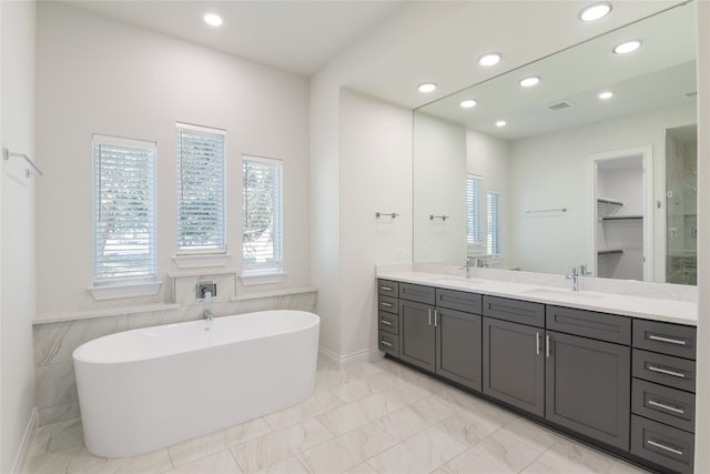 bathroom with shower with separate bathtub and vanity