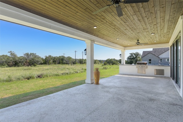 view of patio / terrace featuring ceiling fan, area for grilling, and an outdoor kitchen