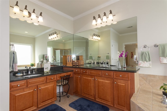 bathroom featuring tile patterned floors, vanity, a shower with shower door, and crown molding