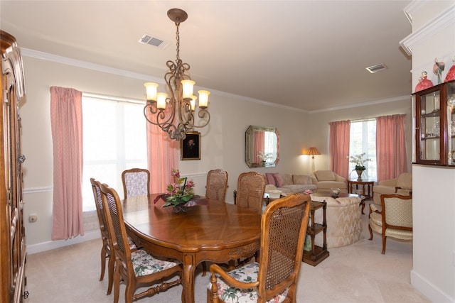 dining area featuring light colored carpet, a chandelier, and ornamental molding