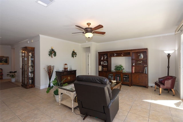 living room featuring ceiling fan, crown molding, and light tile patterned floors