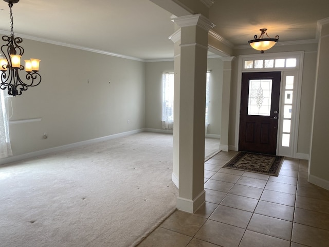 411 Palmetto Dr, Georgetown, TX 78633 - foyer entrance with ornate columns, ornamental molding, light tile patterned flooring, baseboards, and light colored carpet