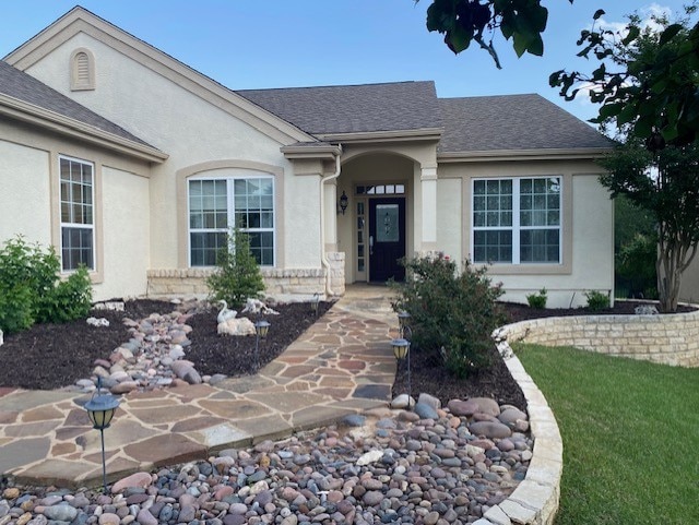 411 Palmetto Dr, Georgetown, TX 78633 - entrance to property featuring stucco siding and roof with shingles