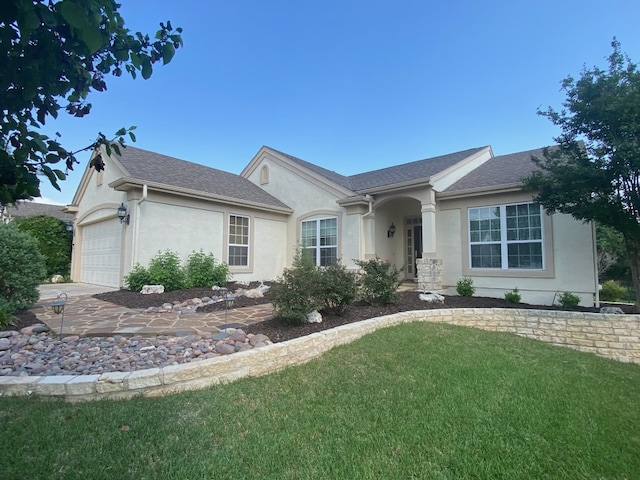 411 Palmetto Dr, Georgetown, TX 78633 - ranch-style house featuring stucco siding, a front lawn, a garage, and driveway