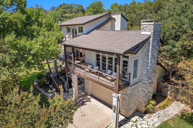 view of front of house featuring stairway, roof with shingles, a chimney, and fence