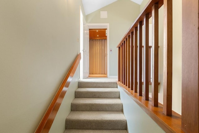 staircase with lofted ceiling