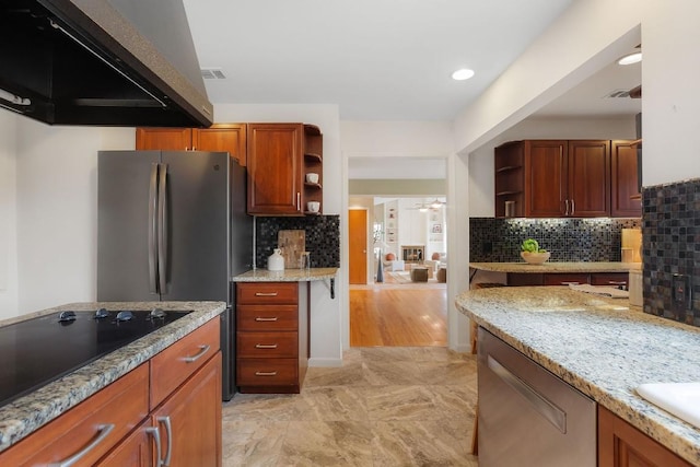 kitchen featuring light stone counters, brown cabinets, open shelves, stainless steel appliances, and exhaust hood