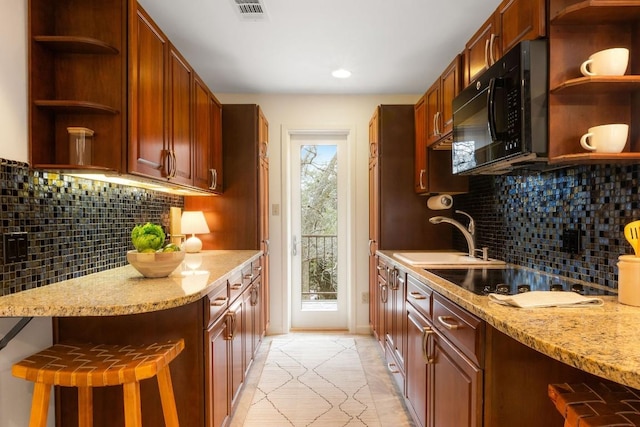 kitchen with black appliances, visible vents, open shelves, and a sink