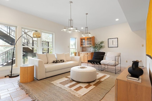 living area featuring recessed lighting and an inviting chandelier