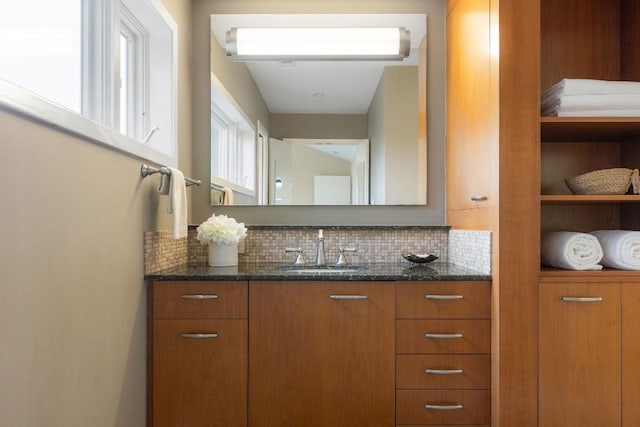 bathroom with vanity and decorative backsplash