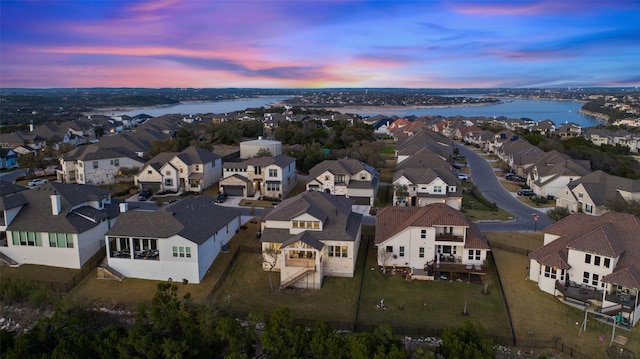 aerial view at dusk with a water view