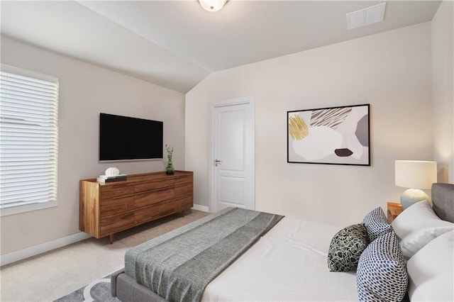 carpeted bedroom with vaulted ceiling