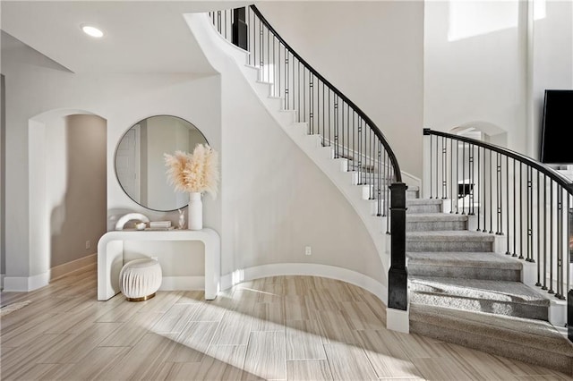 staircase with a high ceiling