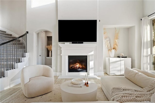 living room with hardwood / wood-style floors and a high ceiling