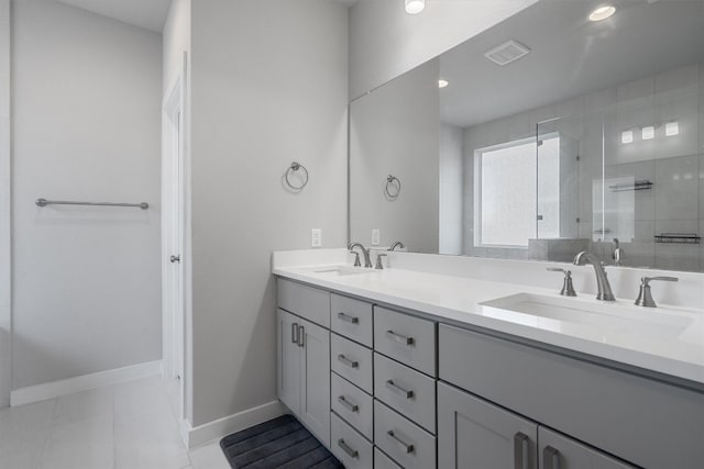 bathroom featuring vanity, walk in shower, and tile patterned flooring