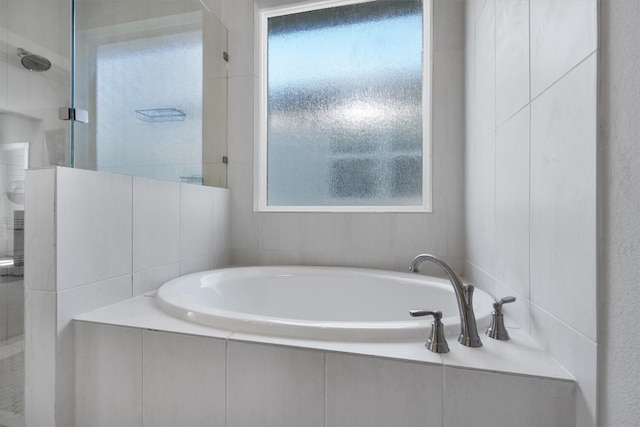 bathroom with plenty of natural light and independent shower and bath