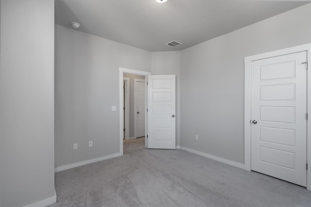 empty room featuring light colored carpet